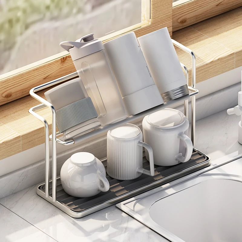 Two-tier aluminium cup rack holding mugs upside down on a kitchen counter